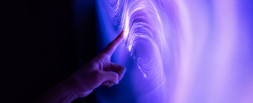 Hand touching a glowing digital display with purple and blue light effects