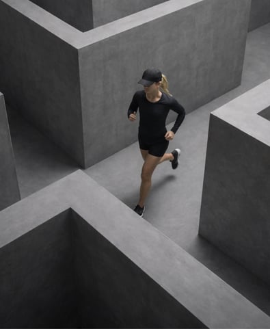 Women in sports clothes running in a maze