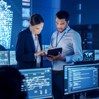 Two people talking about cyber security in a cyber lab
