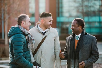 Group of 3 men talking in the cold