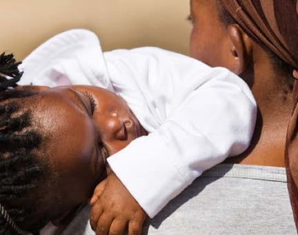 Child asleep on a shoulder