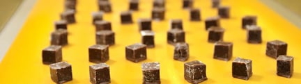 Individual chocolates on yellow tray