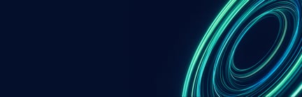 Abstract blue and purple flowing light trails forming circular patterns on a dark background.