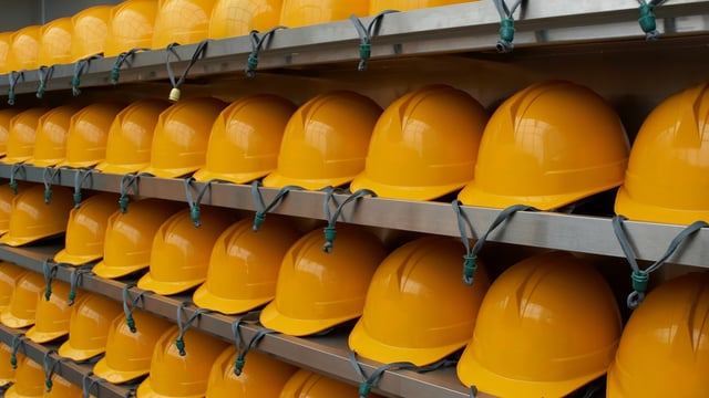 yellow hard hats on shelf